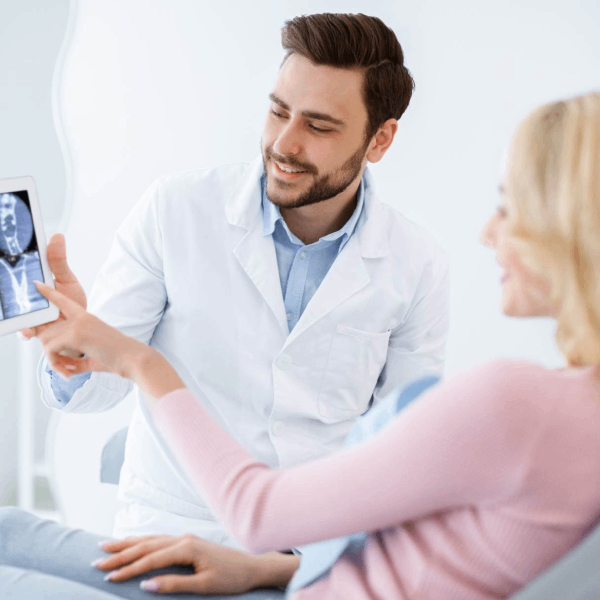 Dentist showing medical imagery to patient