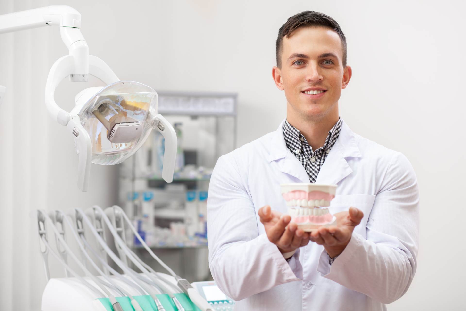 Dentist holding medical material in his clinic