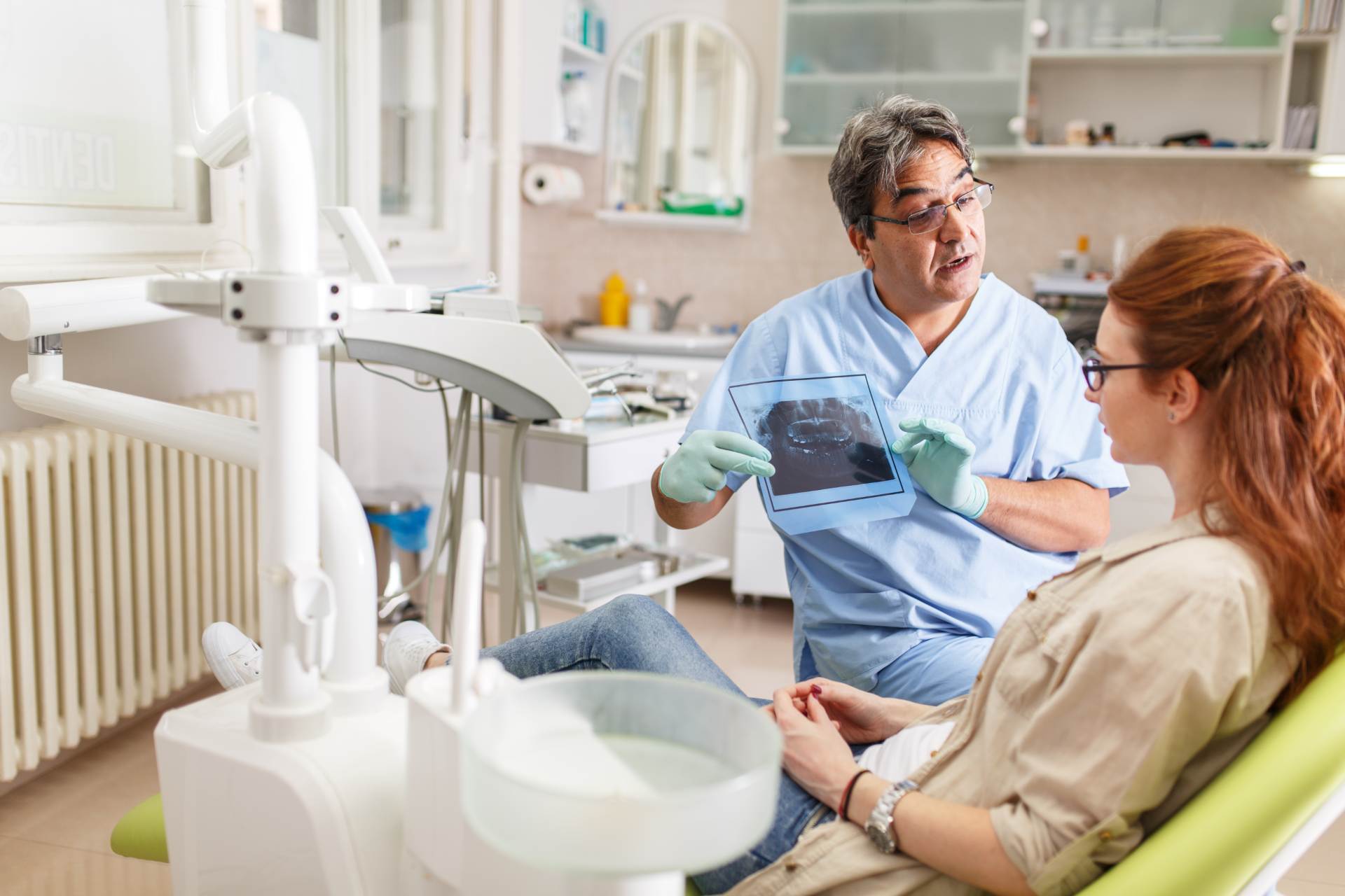 Dentist showing medical imagery to patient